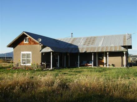 The house on 17 irrigated acres from the Acequia de San Juan Nepomoseno del Llano.  Water rights since 1789 (Photograph by Taos Properties).